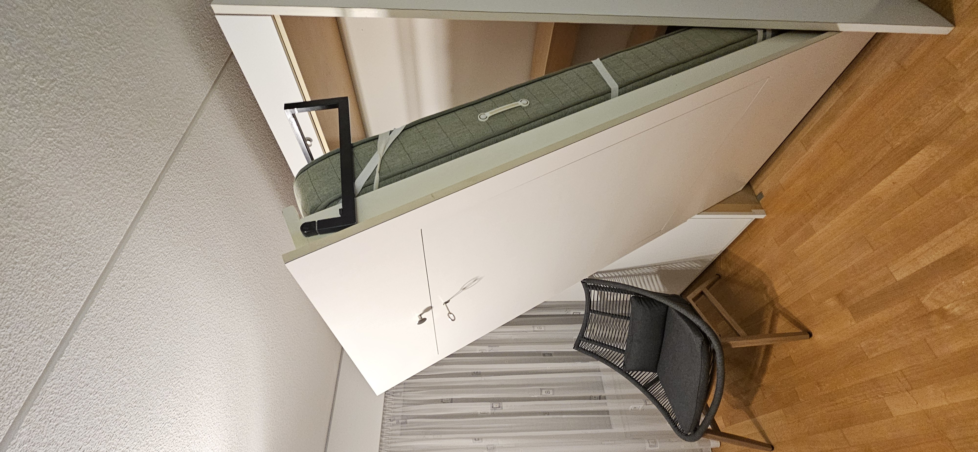 Foldable bed in closed position inside the cabinet
