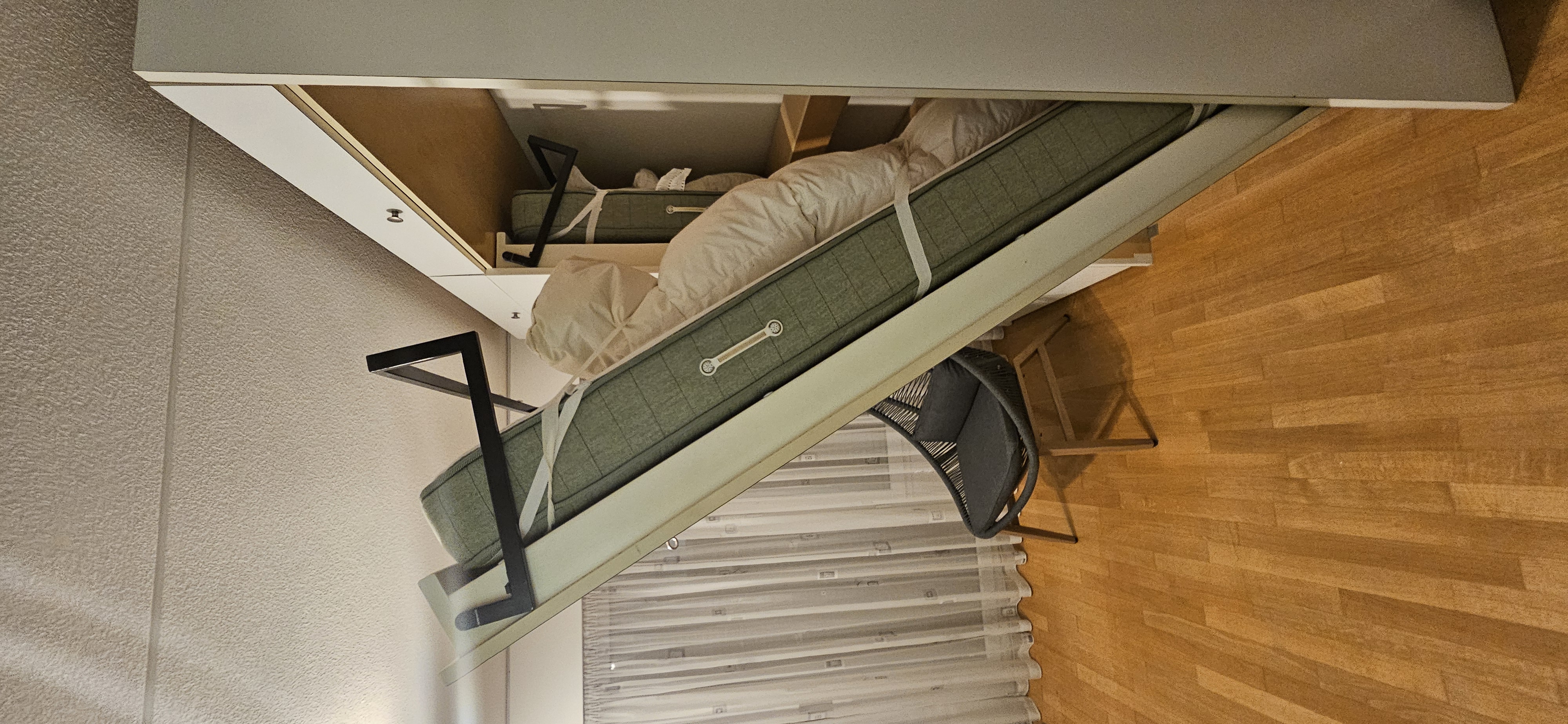 Foldable bed being opened and pulled down